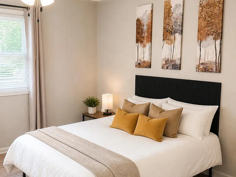 Bedroom features a comfortable bed setup, ceiling fan light, block out drapes with blinds on windows