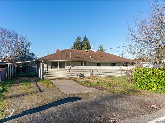 Large driveway that can easily park 4 vehicles. The main entrance is under the carport, but there is also a secondary entrance to the living room on the North side of the home. 