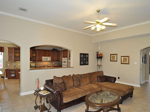 Family room has tile flooring and neutral colors throughout this home.