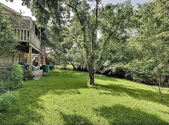 heres plenty of room for pets to run and play on this oversized .62 acre lot, which backs to a charming creek.