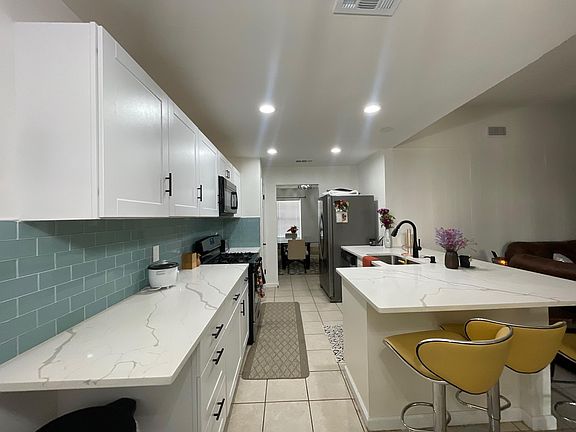 Remodeled kitchen with quartz countertops stainless steel appliances included.