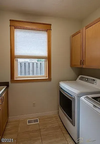 Laundry Room with Washer & Dryer and Cabinet Storage Space