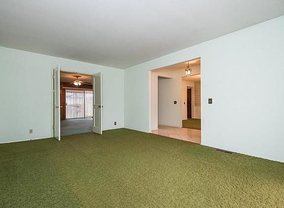 Large living room with double doors to the Family Room.