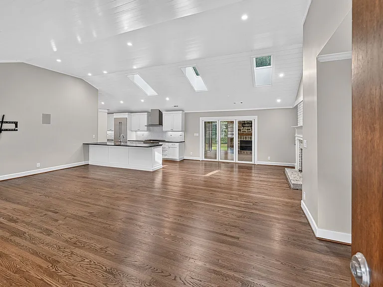 View as you walk into the house - tons of natural light in an open floor plan - perfect for a sectional or multiple couches. Counter bar stools can line the kitchen counter.