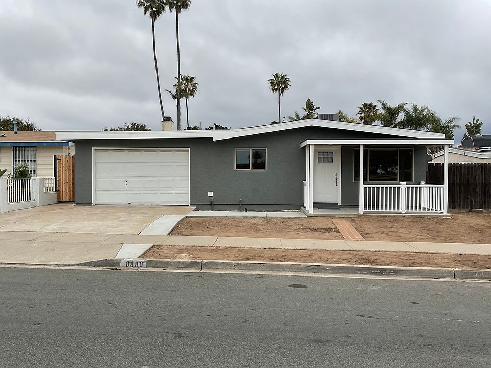 Front of house, front porch, garage and a half, parking for two vehicles in driveway,