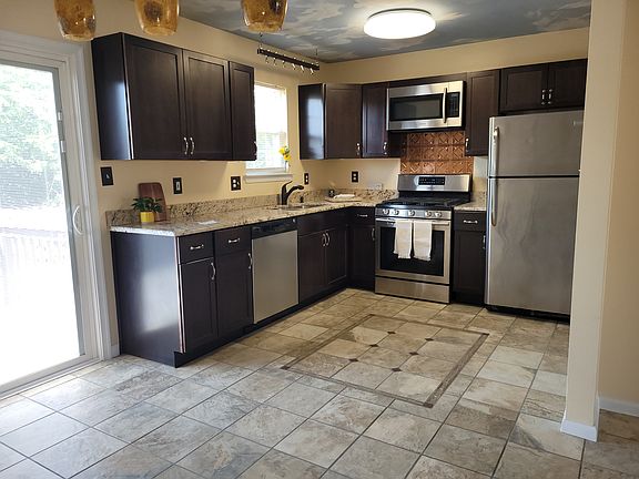 Kitchen with tile flooring, and Stainless Steele appliances