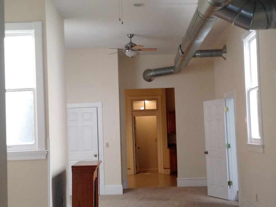 large main room with natural light from 2 atriums with 2 closets in the room