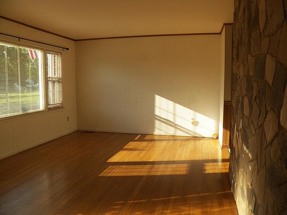 Living rm w/stone wall & distant mountain views