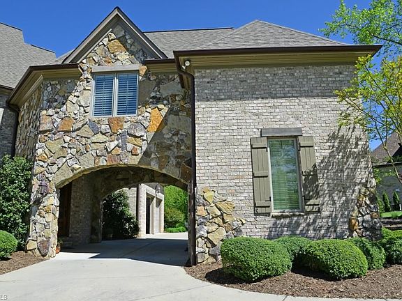 The Porte Cochere! French for automobile entry into inter courtyard. An architectural enhancement to the exterior elevation, it provides a covered area for parking or privacy to rear yard via circular drive.