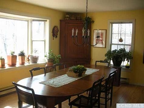 Dining room has room for family to gather and large window looks out on private yard.