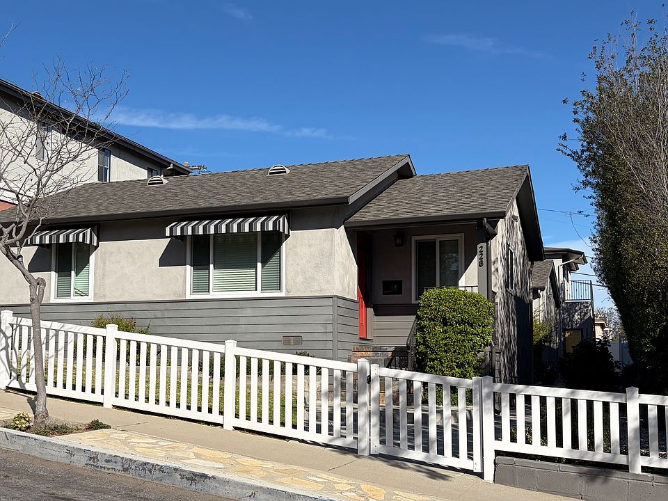 Front view of tri-plex with two stand alone houses in front with unit B in the back.