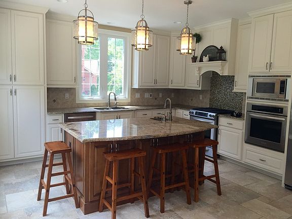 KITCHEN WITH LARGE ISLAND AND 2 BUILT IN OVENS. ONE GAS ONE ELECTRIC