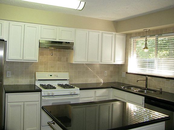 Updated Island Kitchen with granite counter tops overlooking pool area