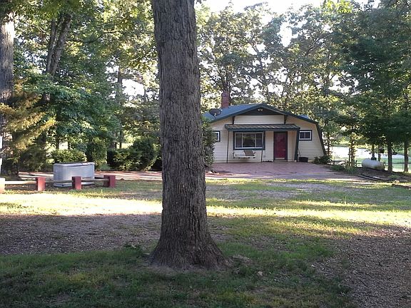 Front entrance near outbuildings, garage and generator.