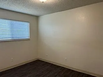 Bedroom #2 with new paint, vinyl plank flooring, and overhead light