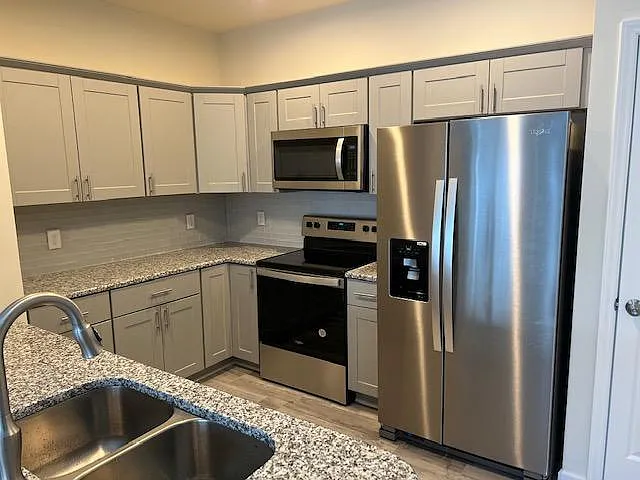 Kitchen with All Steel Appliances and Lazy Susan kitchen cabinet on the corner of Electric Stove Top