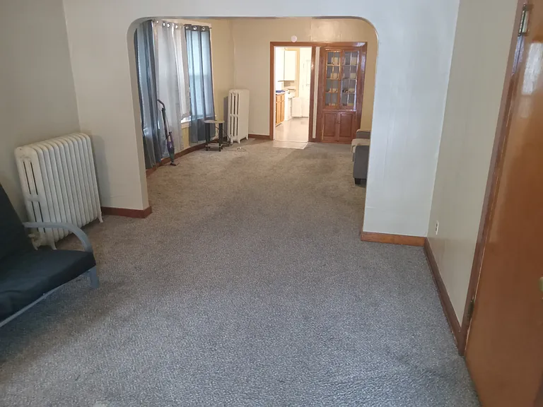 Viewing Front living room leading into dining room with walk-in closet door to the right