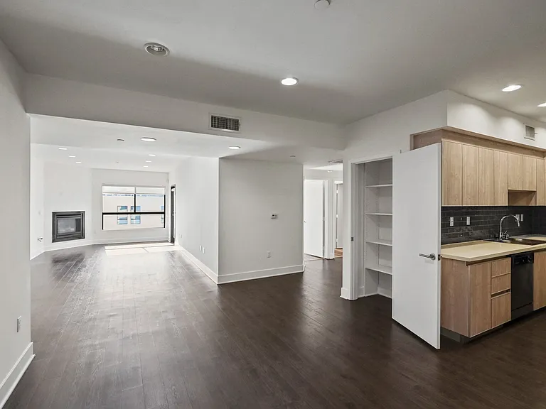 Open-Concept Floor Plan with Kitchen, Dining, and Living Room Area plus a Hall Closet with Built-In Shelving