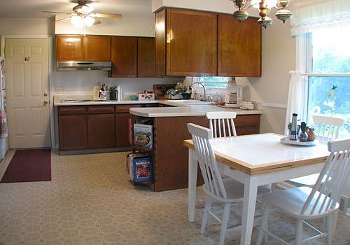 Eat-in kitchen w/chair-rail molding & lighted ceiling fan.