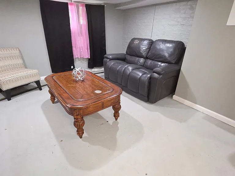 Shared lounge with sofa and accent chair, plus a coffee tablean easy spot to relax or read between activities.