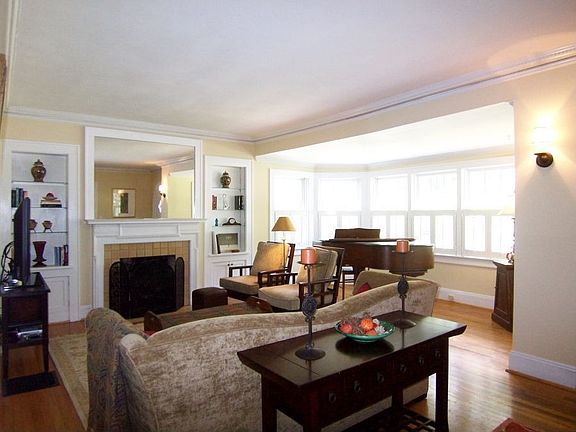 Spacious living room with original tile fireplace and huge bay window adds enough space for baby gra