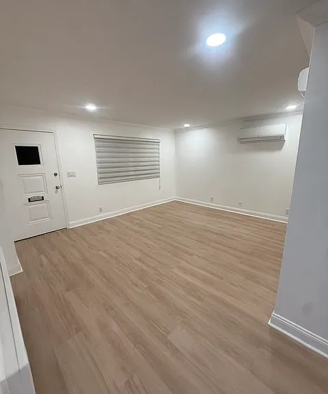 Bright living area with recessed lighting, mini split & new floors