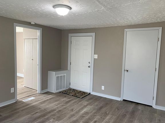 LIVING ROOM FRONT DOOR AND BATHROOM DOOR BEDROOM ON LEFT