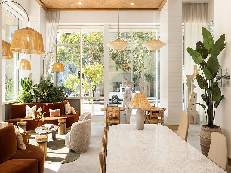 Luxurious and airy living space with plush seating, elegant decor, and abundant natural light streaming through large windows.