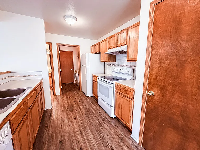 Kitchen with view of laundry room and door to garage