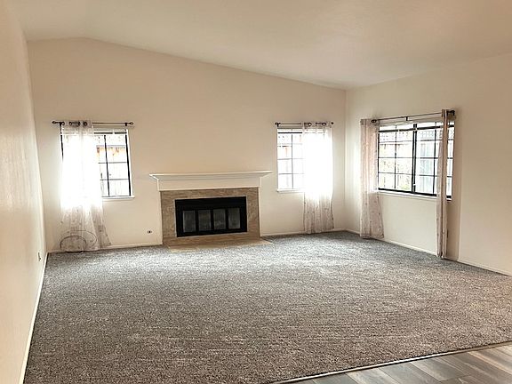Lovely Living Room w/ Gas Log Fireplace, Lots of Windows, & High Ceilings