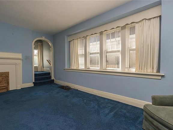 Impressive wall of windows and oversized window sill in living room.
