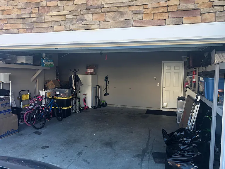 Spacious 2 car garage with shelving already in place!