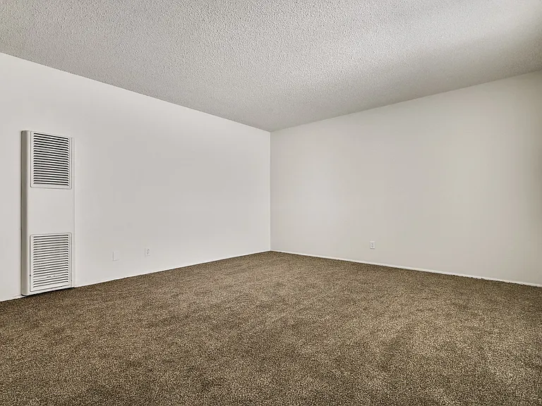 Living room with air conditioning, carpeted floors