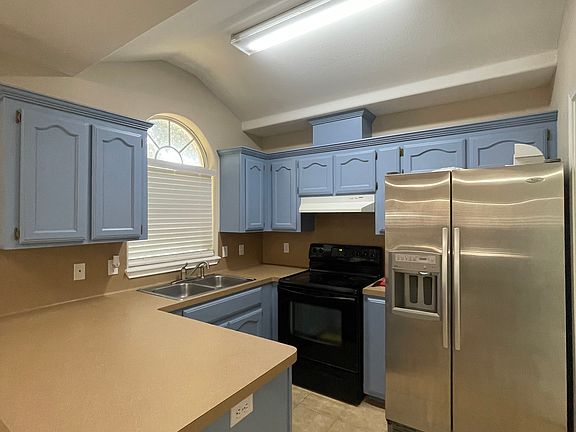 kitchen, range, and fridge