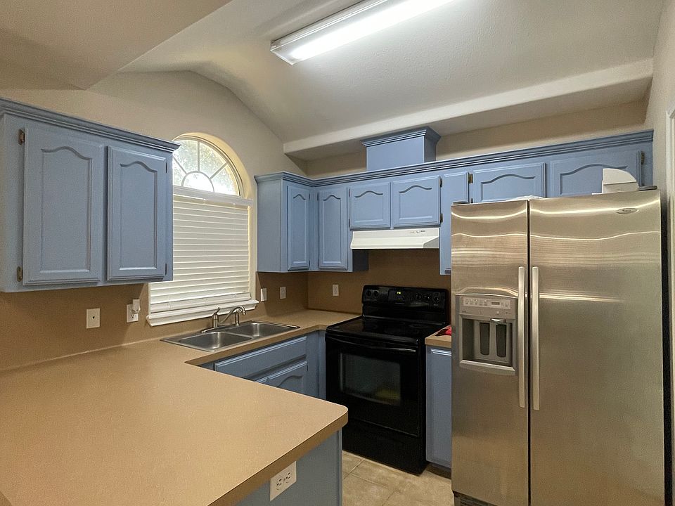 kitchen, range, and fridge