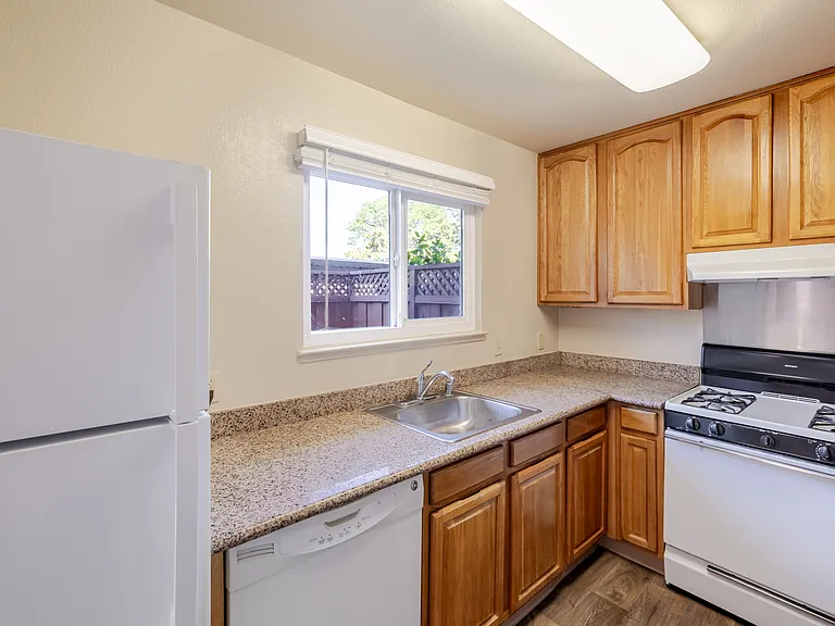 Bright and functional kitchen with ample cabinet space, modern appliances.