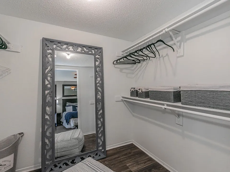 Cozy bedroom design featuring soft carpeting and easy closet access.