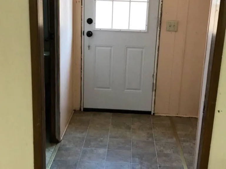 Back door, laundry hookups are on the right and bathroom door on the left.