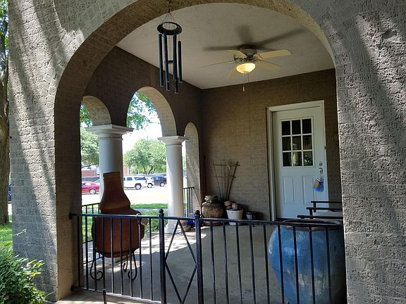 Covered porch with ceiling fan and front entry to 6123 Reiger Ave.