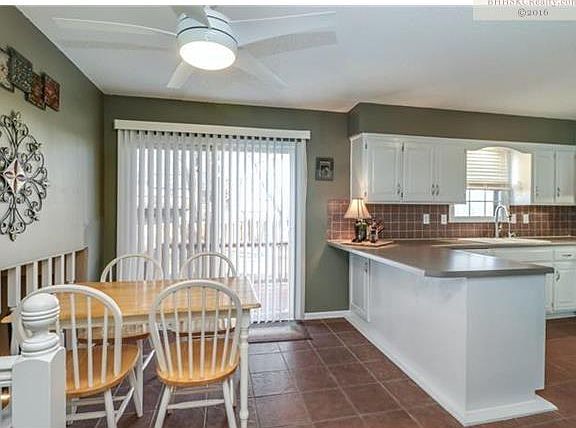 Kitchen Includes Updated Tile Backsplash, Pantry, and Tiled Floor