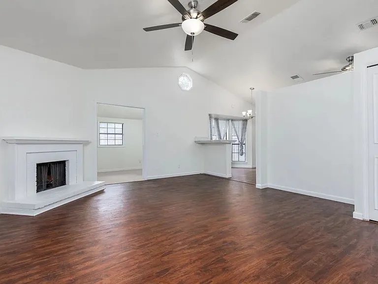 View from front door showing living room, bonus room, and dining space.