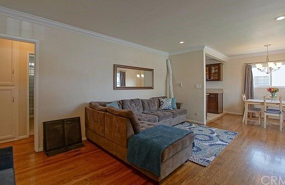 Spacious living room with crown molding and recessed lighting.