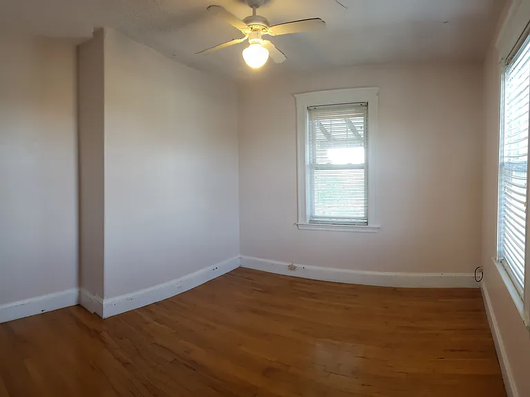 Second bedroom with ceiling fan and 2 large windows