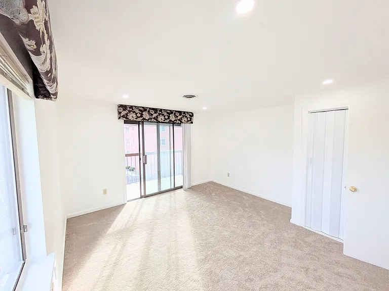 Bedroom with a window and a slider