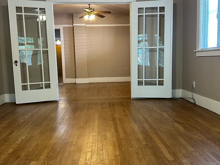 Beautiful big living room with 9' ceilings, and large picture windows with view of I Street.