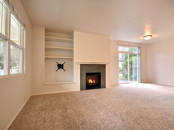 Open-concept living with a gas fireplace perfect for cozying