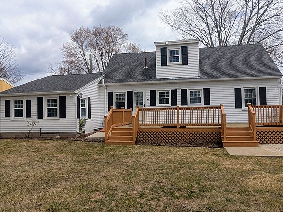 Beautiful, recently painted deck with partially fenced backyard.