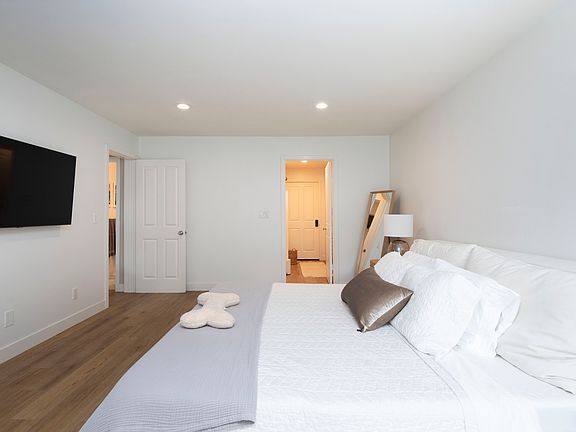 Primary bedroom features a kingsize bed, TV, ensuite fully upgraded bathroom and a large closet!