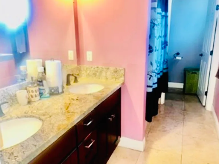 Master Bedroom Full-bath en-suite has His & Hers Vanity and a private Toilet area.