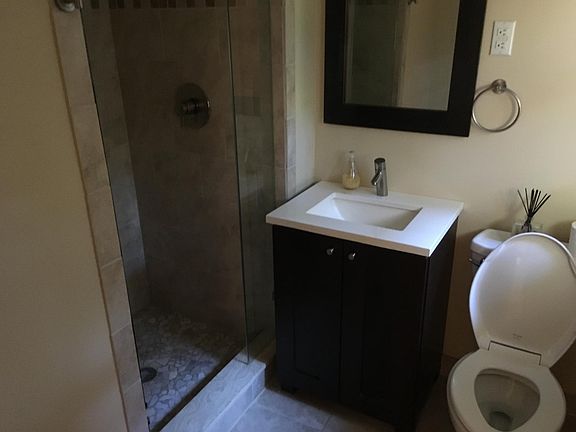 updated tile bathroom with frameless shower door.